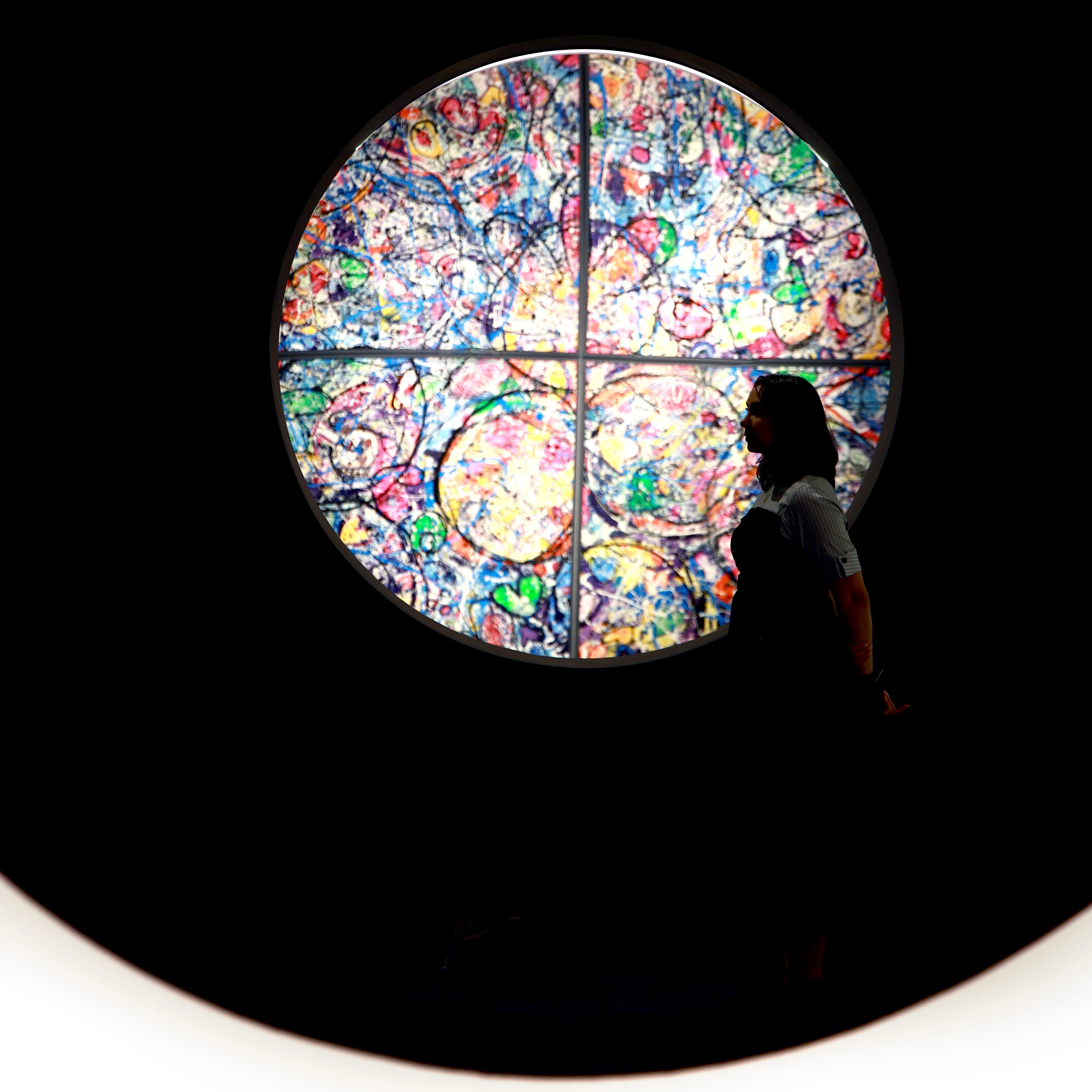 Silhouette before a circular artwork