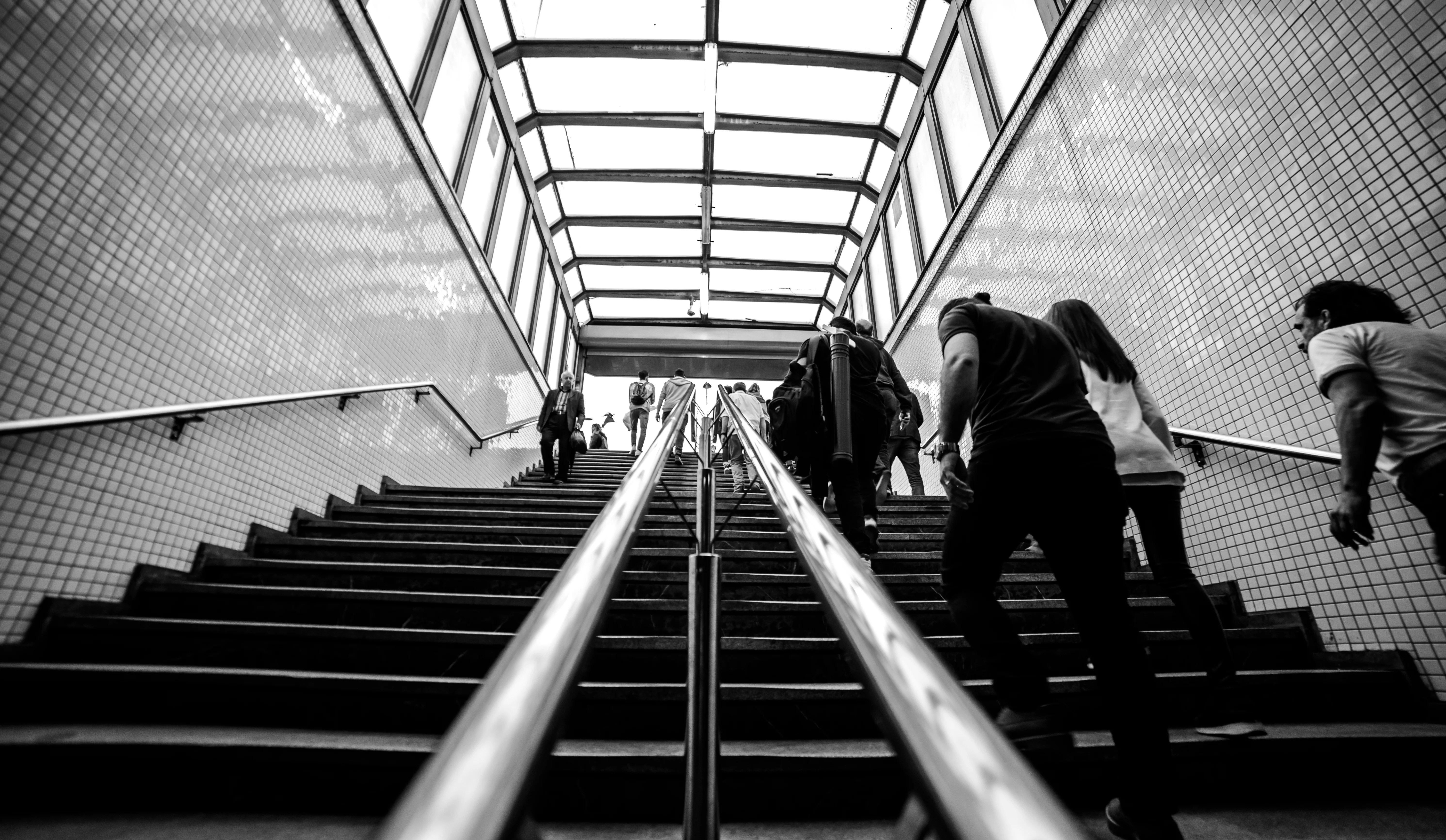 Commuters climbing station stairs